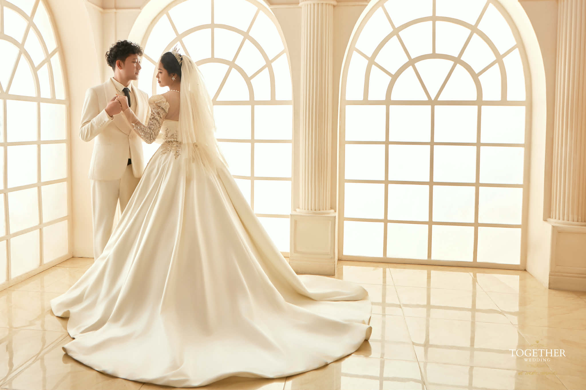 Nay Myo Aung and Khin Myo Nwe in a bright bridal portrait in a grand window-lit hall