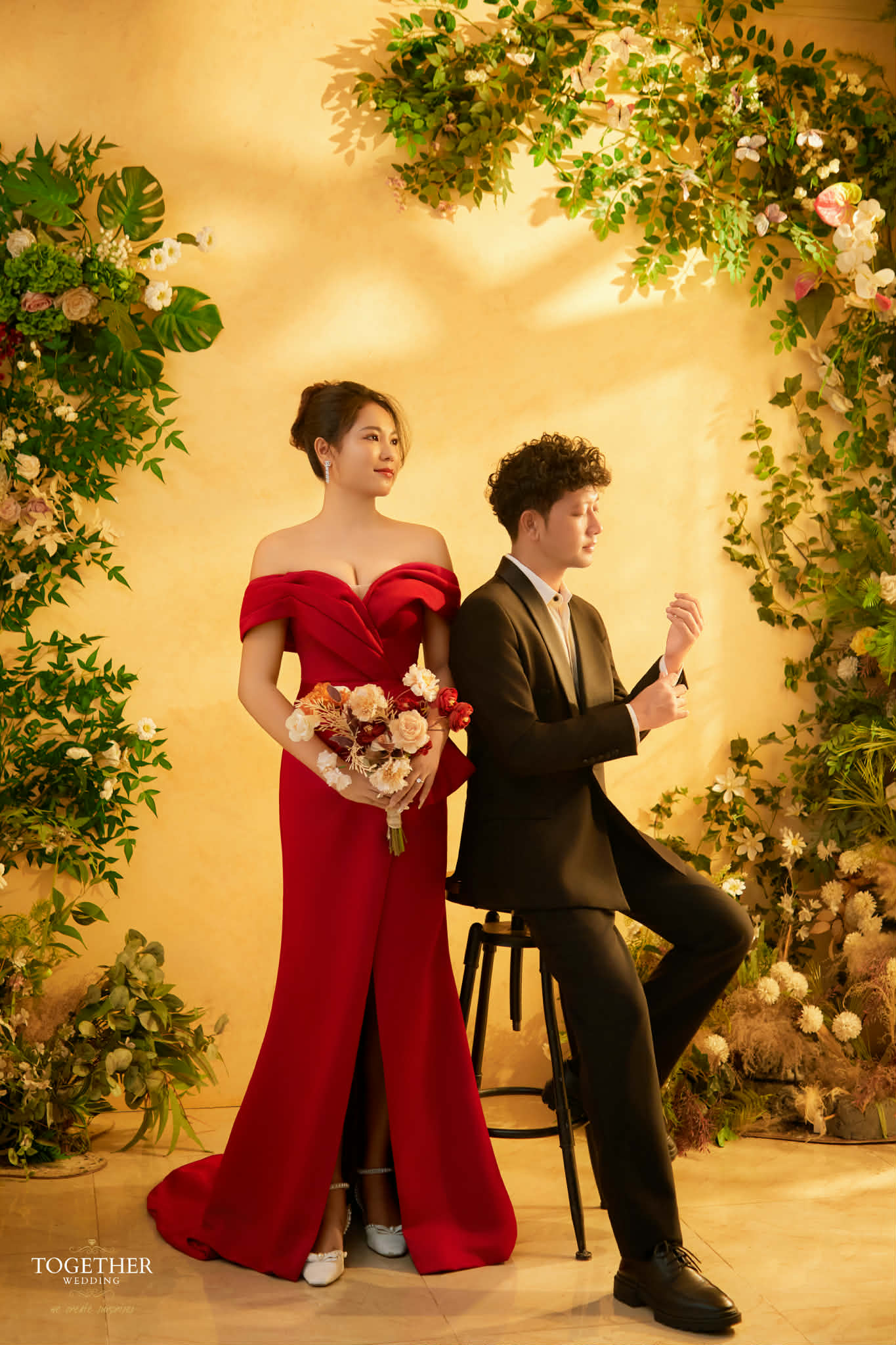 Editorial red gown portrait framed by florals